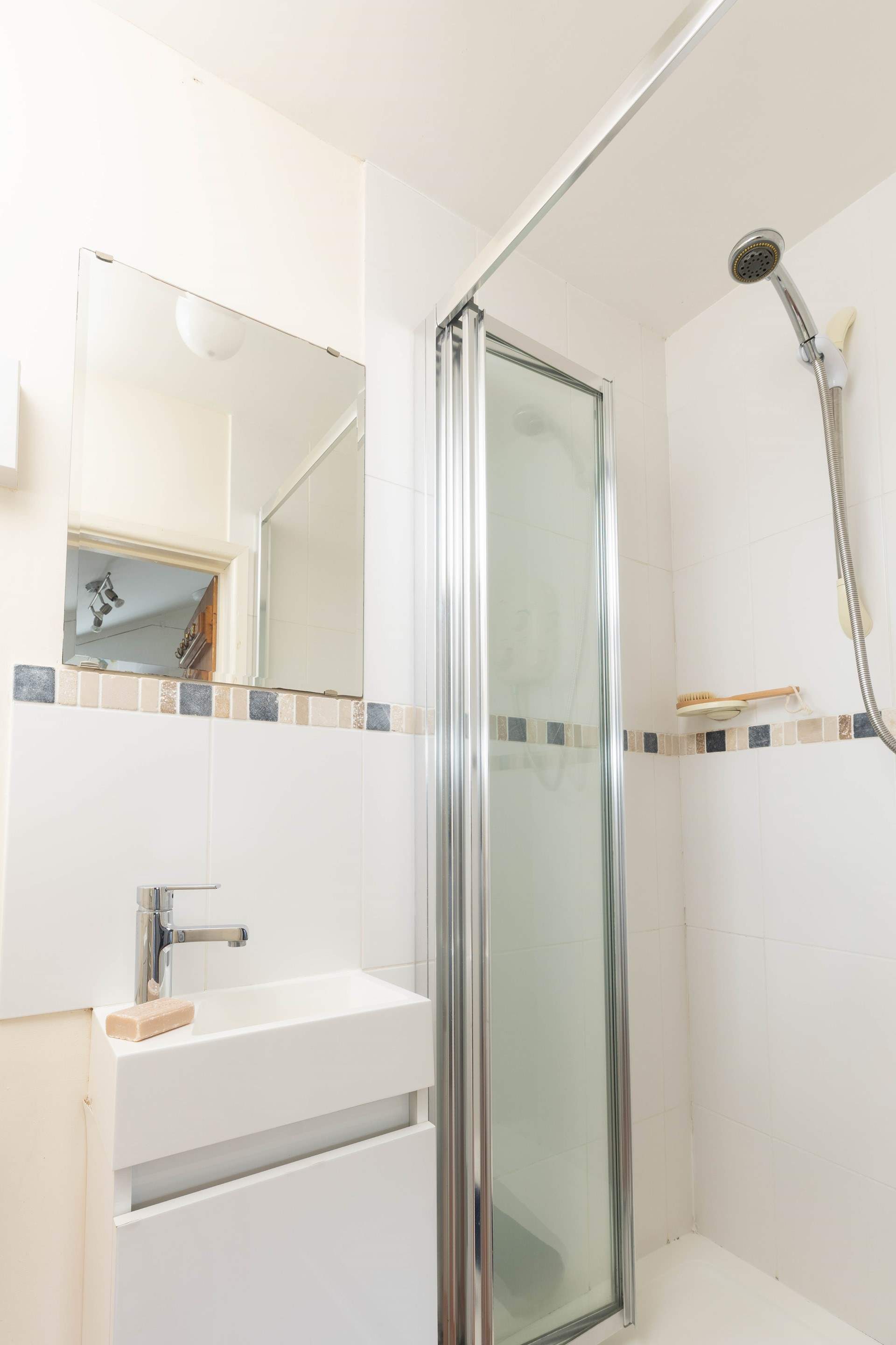 The small shower room is found next to the kitchen. 