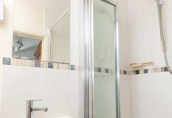 The small shower room is found next to the kitchen. 