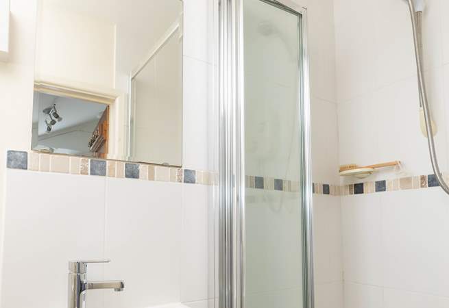 The small shower room is found next to the kitchen. 