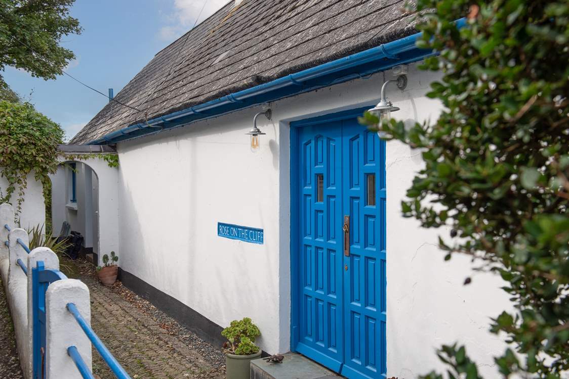 Enter the property through a pair of delightful blue doors.