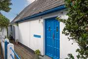 Enter the property through a pair of delightful blue doors.