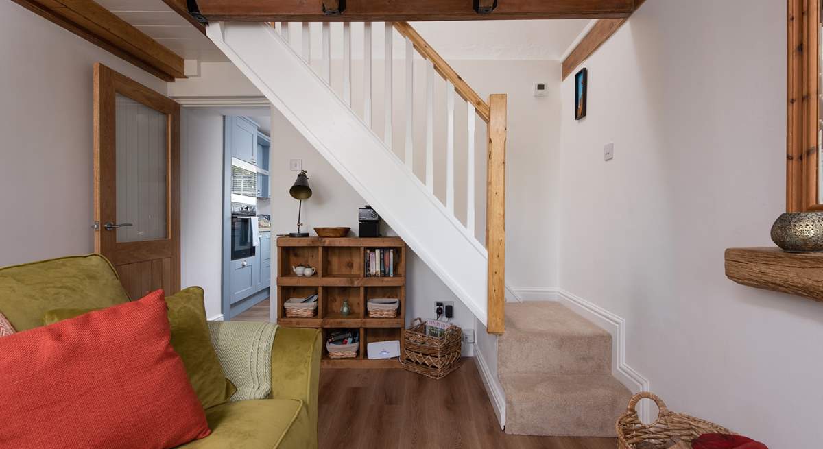 Cottage stairs lead upstairs to the bedroom. 