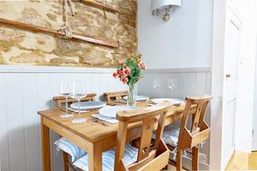 The dining-table is tucked away in the sitting-room, with a fifth chair available.