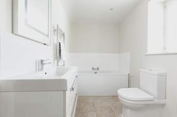 The modern family bathroom has a bath and separate shower cubicle.
