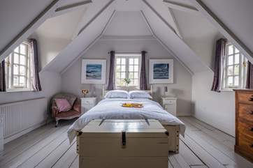 The pretty bedrooms are adorned with lovely linens.