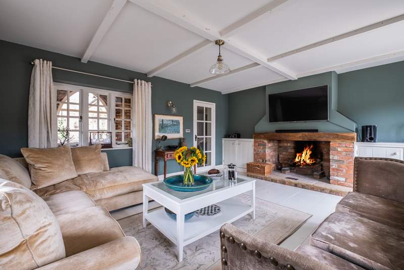 The gorgeous snug has comfy sofas and a fabulous feature fire place.