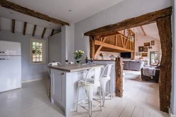 The kitchen island is the perfect place to sit and chat with the chef.