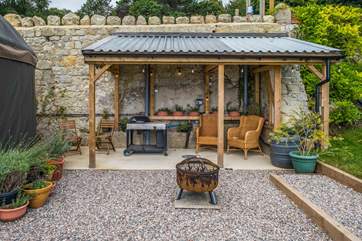 The outside space is amazing. Cosy up around the fire-pit or why not cook under the lean-to?