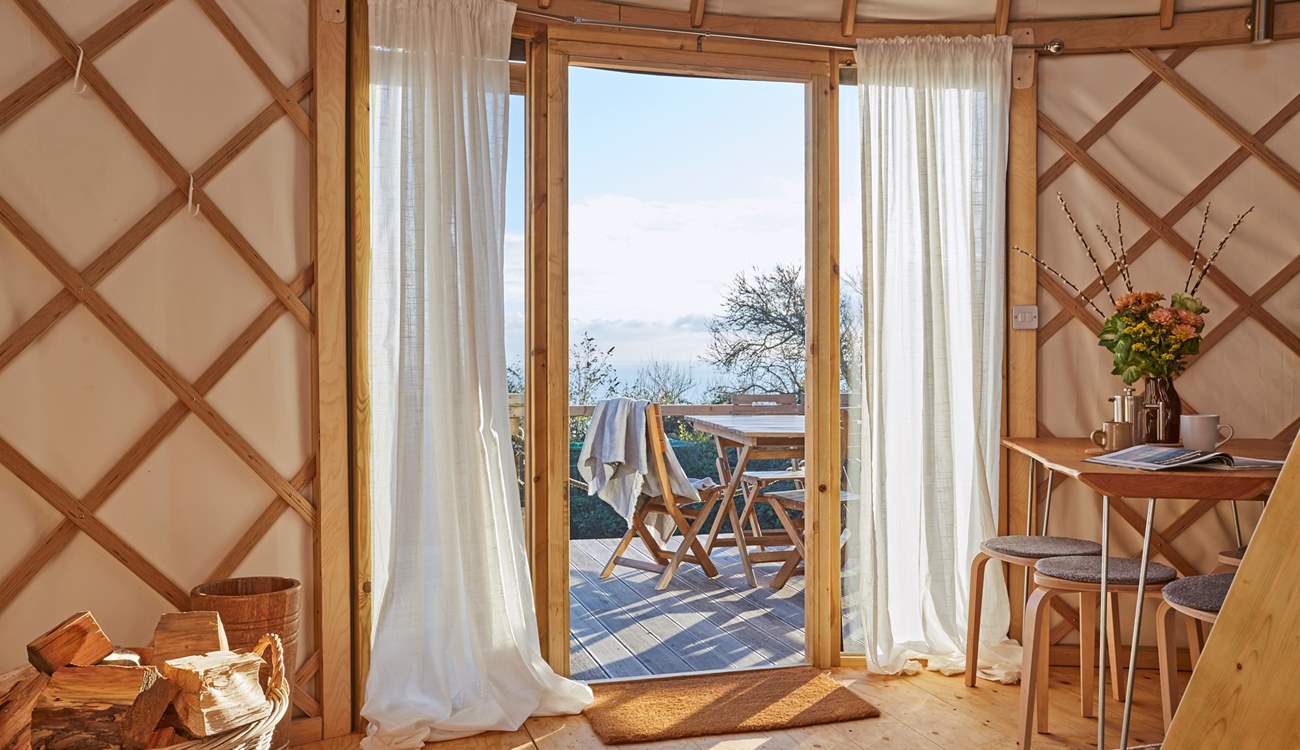 Lovely linens line the floor to ceiling windows from where you can admire the sparkling sea view! 