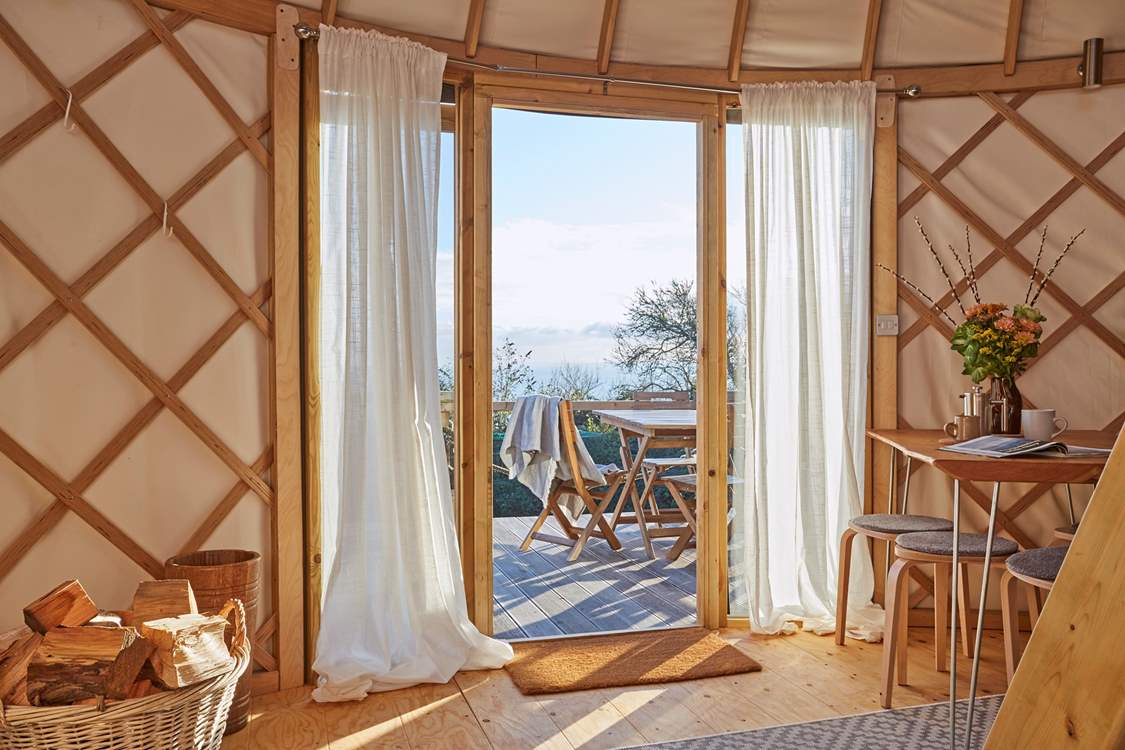 Lovely linens line the floor to ceiling windows from where you can admire the sparkling sea view!