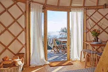 Lovely linens line the floor to ceiling windows from where you can admire the sparkling sea view!