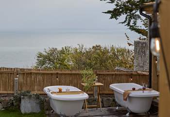 Bathe under open skies overlooking shimmering ocean. 