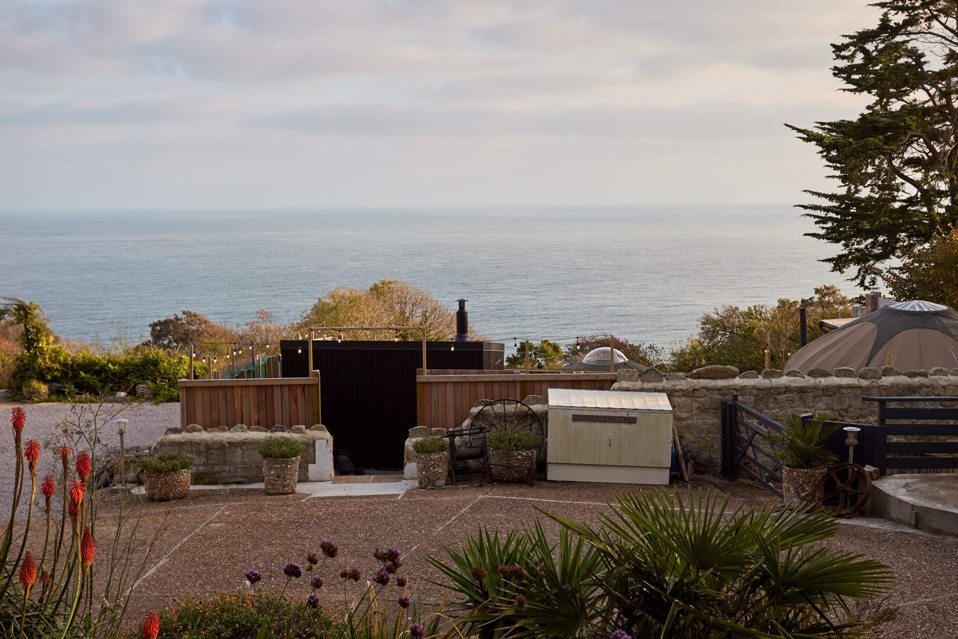The outdoor spa enjoys stunning views over a blue horizon.