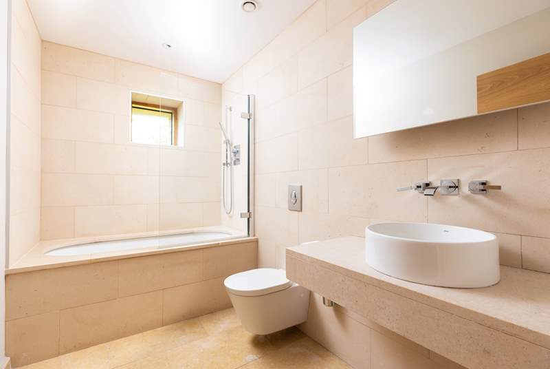 Treat yourself to a relaxing soak in the beautifully minimal en suite bathroom.