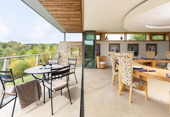 Bi-folding doors brilliantly open up the room to the fresh Cotswold countryside.
