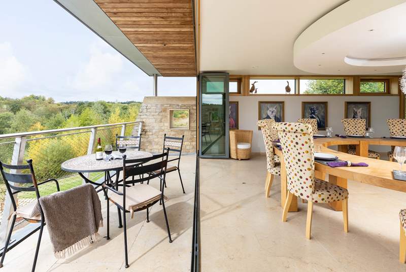 Bi-folding doors brilliantly open up the room to the fresh Cotswold countryside.