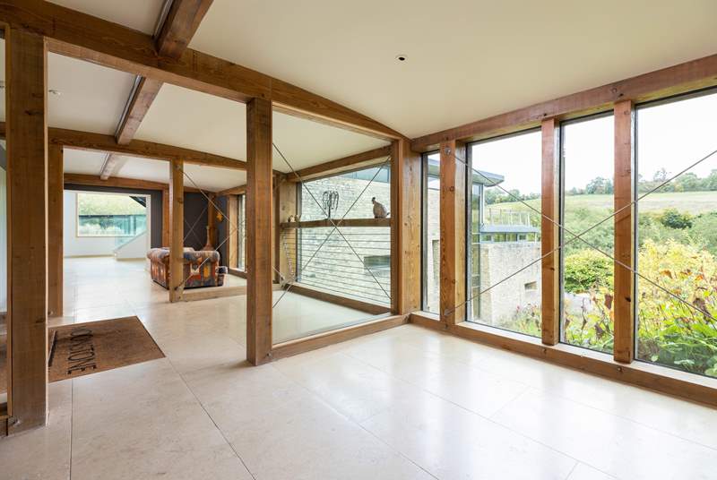 Floor-to-ceiling windows provide gorgeous views across the surrounding Cotswold countryside in the fantastic entrance hall.