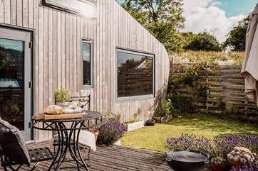 The garden space is full of beautiful plants and there's even a fire pit to cosy up by as the sun sets.
