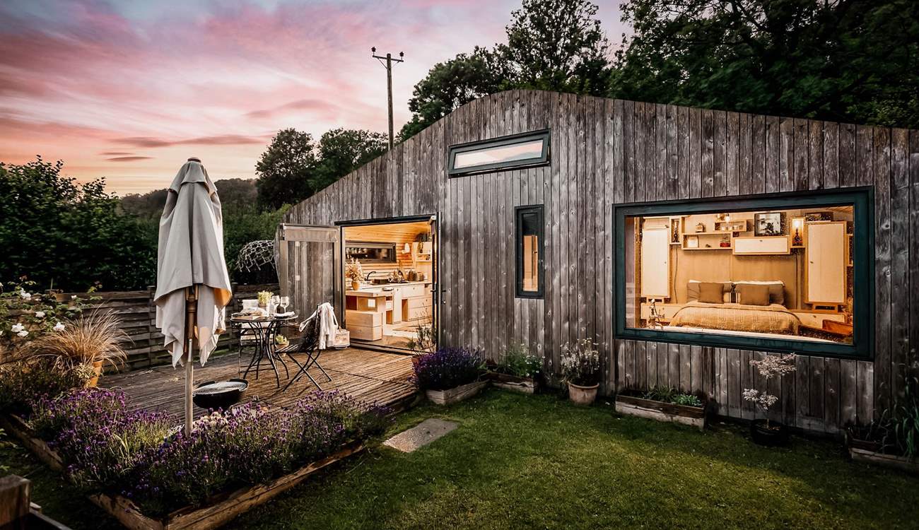 As dusk falls, the cabin transforms into a magical haven. 