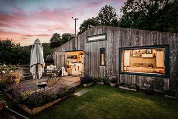 As dusk falls, the cabin transforms into a magical haven.