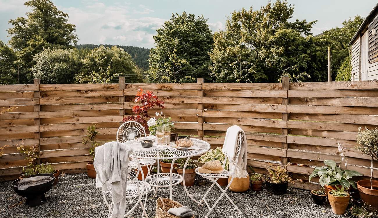 Surrounded by pretty potted plants and gorgeous green pastures. 
