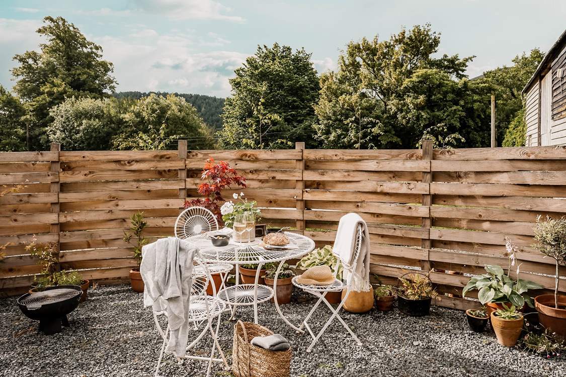 Surrounded by pretty potted plants and gorgeous green pastures.