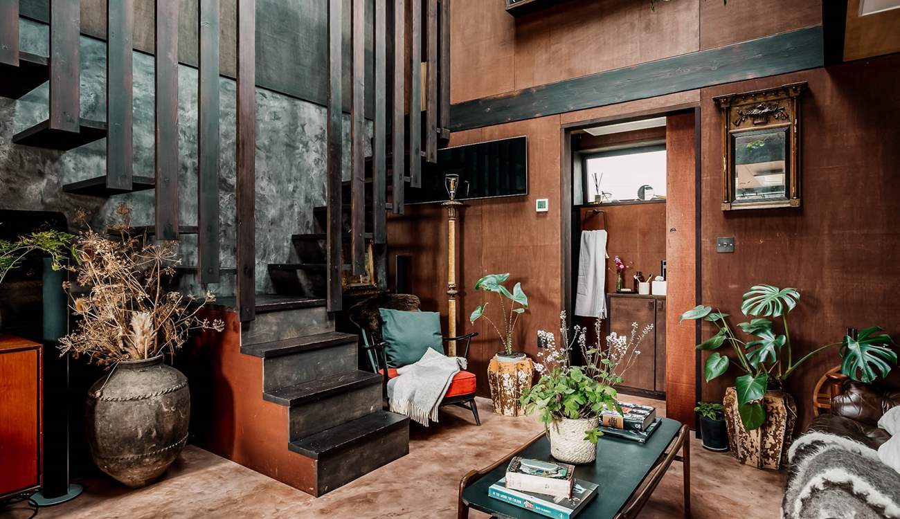 Climb the stairs on the left to the main bedroom, or on the right to the incredible bathtub. 