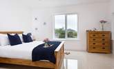 The main bedroom has a comfy king-size bed and a view of St Michael's Mount. - Thumbnail Image