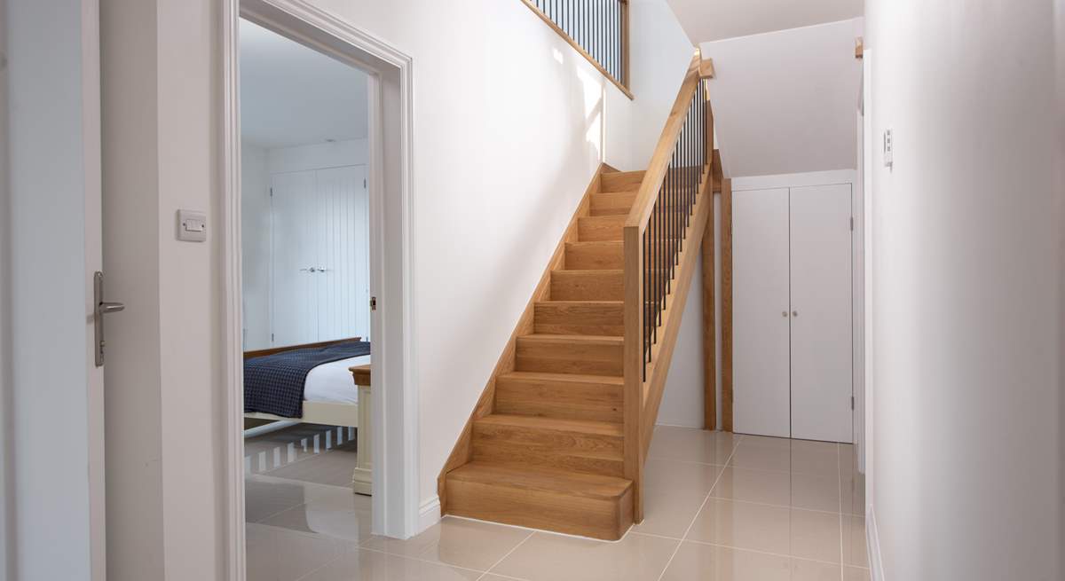 The front door leads into the hallway, bedrooms and bathroom with the staircase leading to the first floor living space.