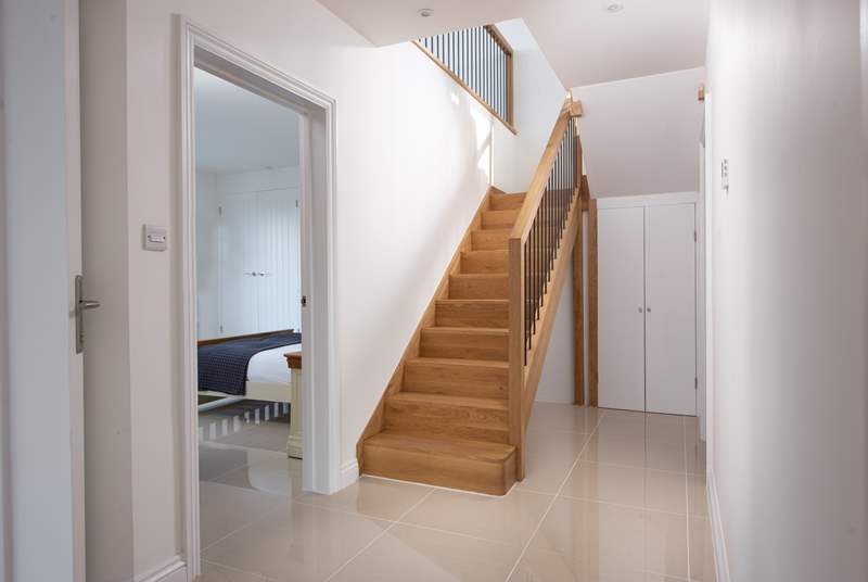 The front door leads into the hallway, bedrooms and bathroom with the staircase leading to the first floor living space.