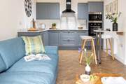 A brilliant open plan living space greets you as you enter.