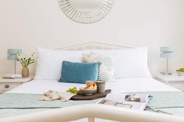 An indulgent king-size bed sits in the centre of the room.