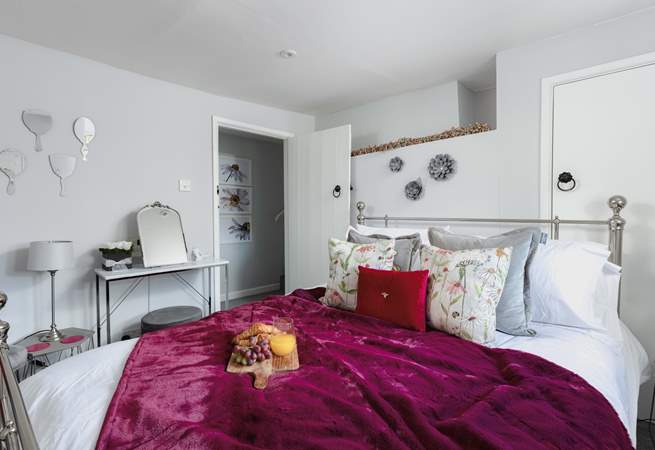 This sumptuous bedroom has a king-size bed.