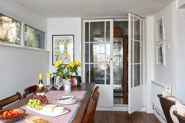 Plenty of space for everyone around the dining-table. The handy pantry leads off the dining area with an additional large fridge.