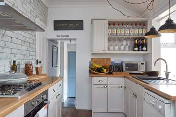 The kitchen is beautifully crafted and finished with statement lighting. A second fridge can be found in the pantry and there's a separate utility-room with washing machine, tumble-drier, WC and basin.