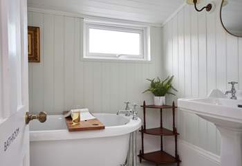 The stunning family bathroom with roll-top bath can be found on the half landing.