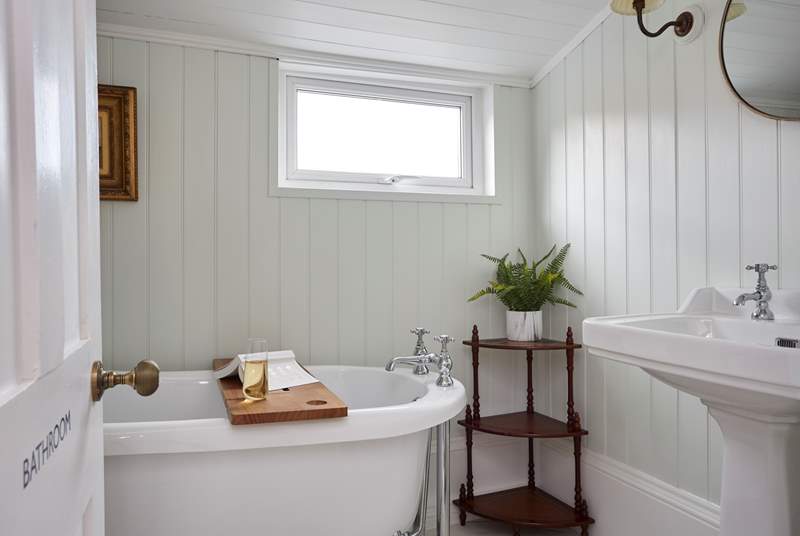 The stunning family bathroom with roll-top bath can be found on the half landing.