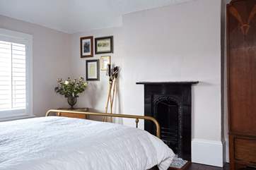 A lovely ornamental fireplace in bedroom 3.