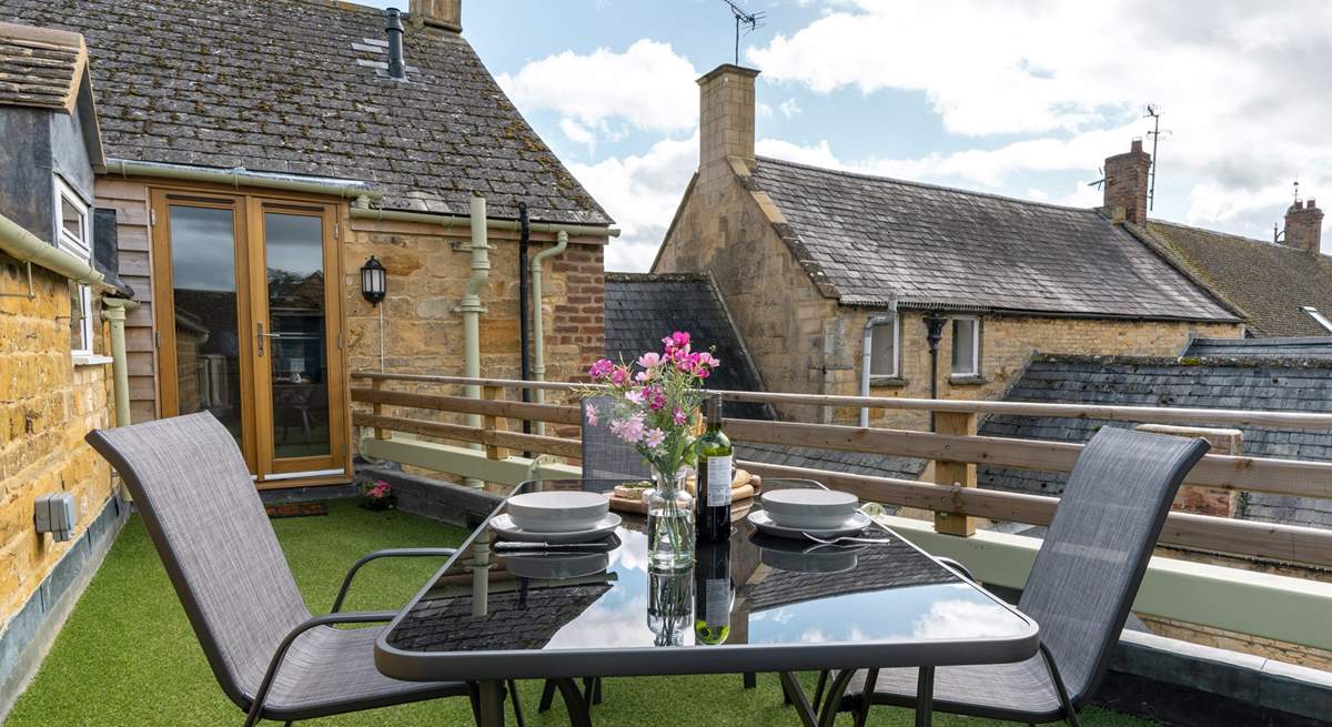 The terrace is outside the kitchen, overlooking surrounding rooftops.