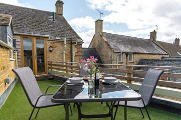 The terrace is outside the kitchen, overlooking surrounding rooftops.