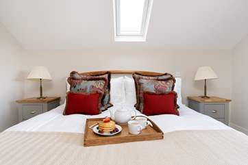The gorgeous main bedroom has a super-king size bed for a restful night's sleep.