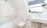 The stylish family bathroom has a bath with fitted shower. - Thumbnail Image