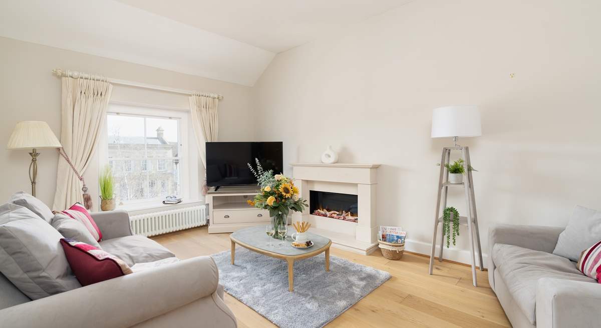 The cosy sitting-room has a luxurious sofa and a top of the range fire.