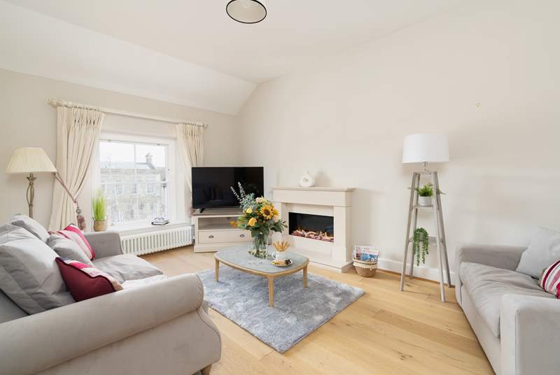 The cosy sitting-room has a luxurious sofa and a top of the range fire.
