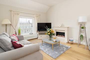 The sitting-room is elegantly styled with beautiful furnishings.
