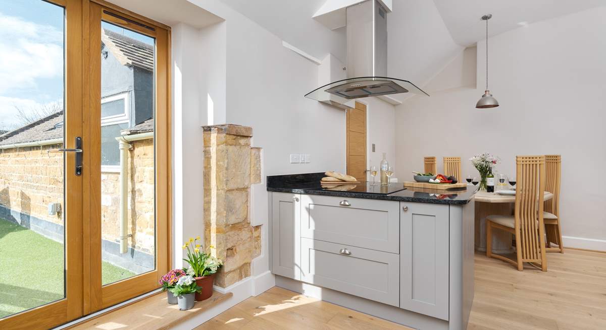 The spacious kitchen has French doors leading out to the terrace.