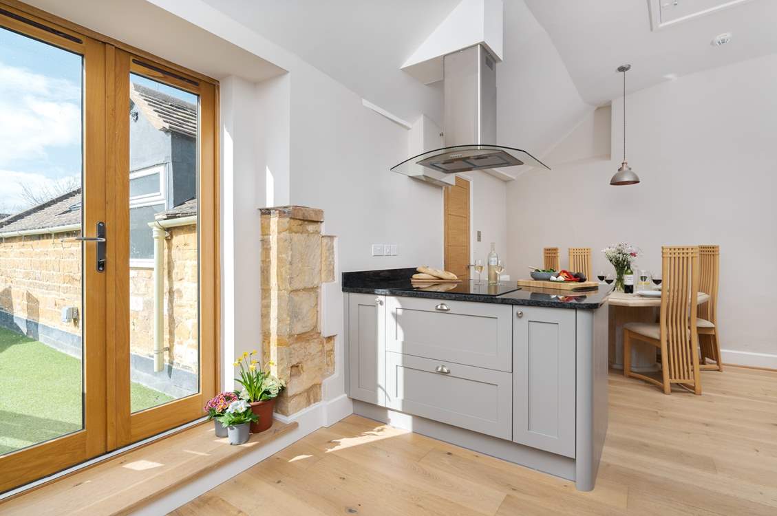 The spacious kitchen has French doors leading out to the terrace.