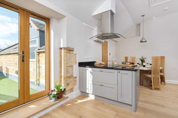 The spacious kitchen has French doors leading out to the terrace.