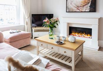 Sit by the glow of the top-of-the-range electric fire, beautiful to look at and giving a cosy boost of heat if you need it although the apartment has full under-floor heating.