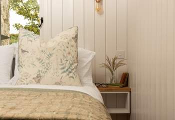 Gorgeous cushions and lovely linens adorn the bed.